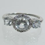 A 10 carat white gold topaz and diamond cluster ring
