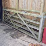 A wooden five bar gate, together with another,