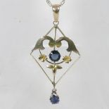 An early 20th century yellow metal openwork pendant, set with sapphires,