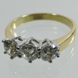 An 18 carat gold three stone diamond ring, approximately 1.