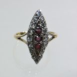 An early 20th century 18 carat gold ruby and diamond cluster ring, of elliptical shape,