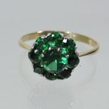 An 18 carat gold and green gem set cluster ring,