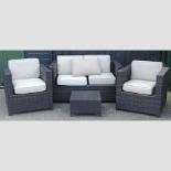 A woven four piece garden patio set, with loose cushions, comprising a sofa, 136cm,