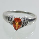 A 9 carat white gold fire opal and diamond set dress ring