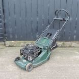 A green Atco rotary petrol lawn mower