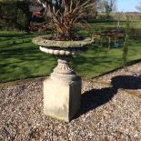 A reconstituted stone garden urn on plinth base, of large proportions, approx.