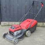 A black Mountfield petrol rotary lawn mower,