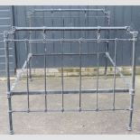 An early 20th century black painted iron double bedstead,