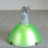 A green painted metal industrial light fitting,