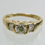 An 18 carat gold and diamond three stone ring,