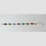 A yellow gold bracelet, set with carved coloured hardstone cabochons,