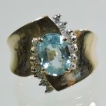 A large 14 carat gold, blue topaz and diamond set ring,