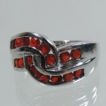 A 9 carat white gold and fire opal channel set ring,