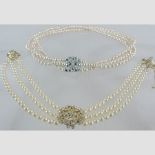 A simulated pearl three strand necklace, together with another,