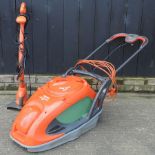 A Flymo guide master electric lawn mower together with a Flymo strimmer