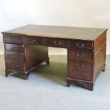 A reproduction mahogany twin pedestal desk, with a leather inset top,