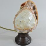 A carved cameo shell, converted to a table lamp, 20cm tall,