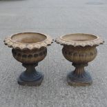 A pair of terracotta campana shaped garden urns,
