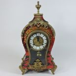 A boulle style brass and faux tortoiseshell mantle clock, with an enamel dial,