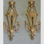 A pair of gilt painted mirrored wall sconces,