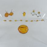 A collection of amber jewellery to include two sets of earrings, a brooch,