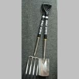 A stainless steel garden fork and spade