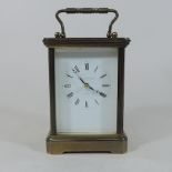 A brass cased carriage clock, with a white enamel dial, by Matthew Norman,