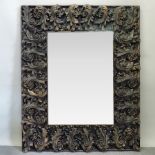 An ornate painted plaster wall mirror, of large proportions,