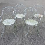A set of four white painted iron garden armchairs