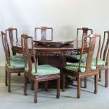 A good quality Chinese rosewood circular dining table, 152cm, with a glass top,
