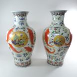 A pair of Chinese porcelain baluster shaped vases, decorated with goldfish,