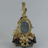 A gilt painted bronze mirror, in the form of a cherub and a lute,