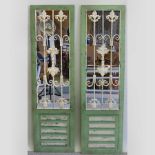 A pair of green painted mirrored door panels,