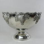 A plated punch bowl, relief decorated with grapes and vines,