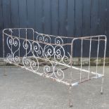 A painted antique iron folding cot,