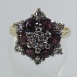 An 18 carat gold ruby and diamond cluster ring