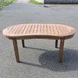 A teak kidney shaped garden table,