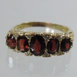 An 18 carat gold and garnet ring,