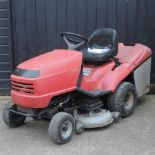 A red Honda hydrostatic petrol ride on lawn mower
