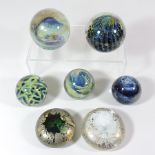 A collection of Isle of Wight coloured glass paperweights, to include a signed Michael Harris,