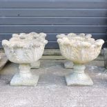A set of four reconstituted stone pedestal garden planters,