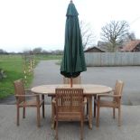 A teak extending garden table, 155cm,