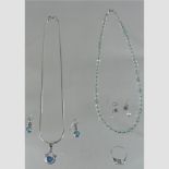 A topaz silver necklace with matching earrings, together with an aqua coloured gemstone necklace,