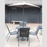 A modern glass top garden table, 88cm diameter,