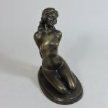 A bronze figure of a kneeling nude lady