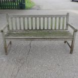 A hardwood slatted wooden garden bench,