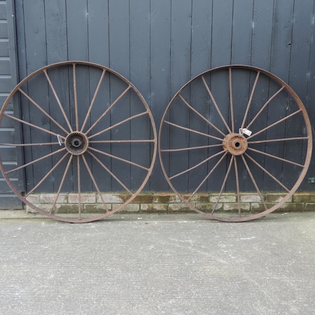 A pair of antique iron cartwheels,