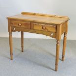 A pine side table, containing two drawers,