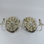 A pair of decorative silver plate wall lights,