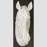 A white painted plaster horse head,
